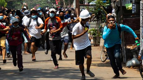 Protesters are seein running from security forces on Saturday in Yangon, Myanmar.