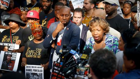 Gwen Carr, right, the mother of chokehold victim Eric Garner, is surrounded by supporters as she speaks during a press conference outside NYPD headquarters. 