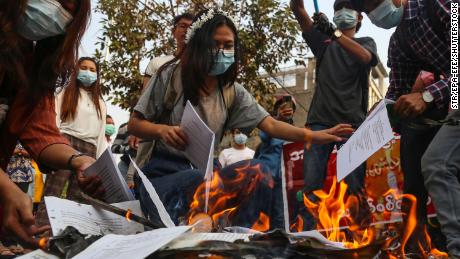 Demonstrators burn a copy of Myanmar&#39;s constitution during a protest against the military coup in Mandalay, Myanmar, on April 1. 