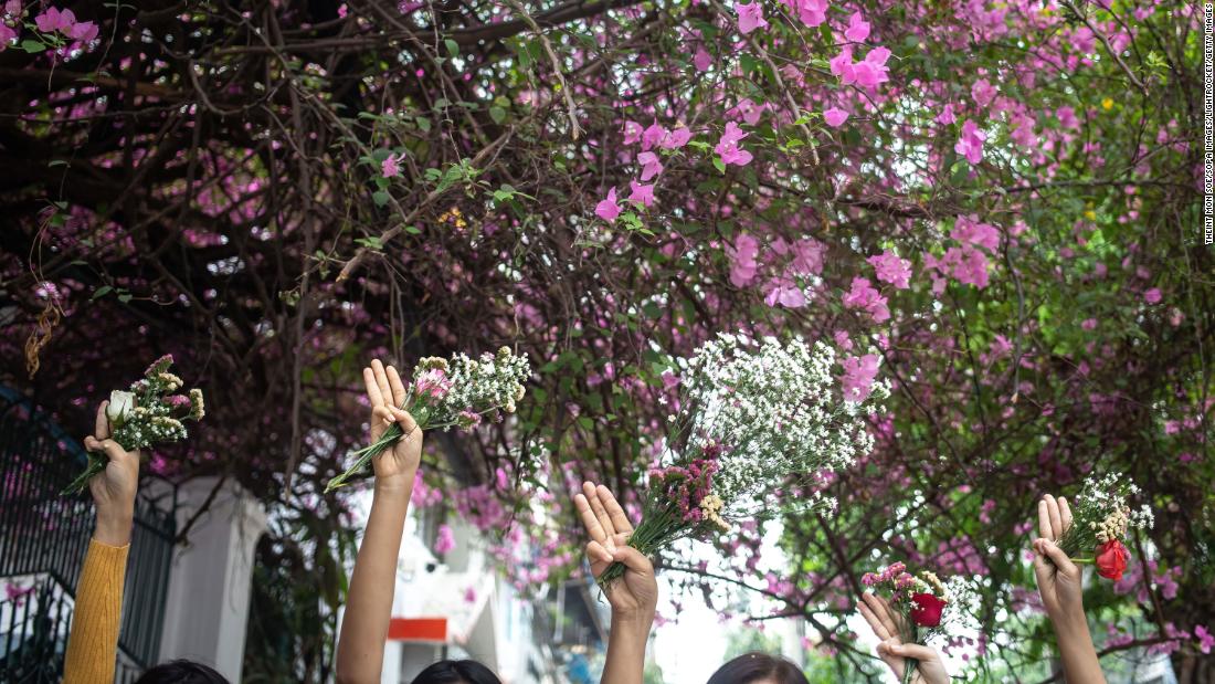 People take part in a &quot;flower strike&quot; in Yangon on April 2.