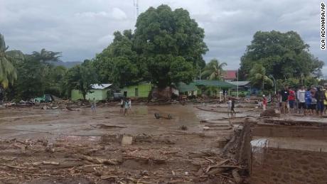 Residents inspect the damage at a village hit by flash floods in East Flores, Indonesia