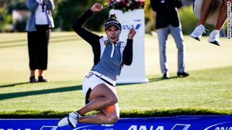 Patty Tavatanakit jumps into the water after winning the ANA Inspiration.