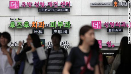 Signs for plastic surgery clinics are displayed on a building in the Apgujeong-dong area of Gangnam district in Seoul, South Korea, on August 3, 2013. 