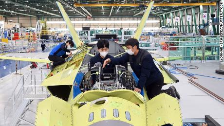 A handout photo released by KAI shows workers of Korea Aerospace Industries (KAI) assemble the first prototype of South Korea&#39;s indigenous fighter jet at its plant in the southeastern city of Sacheon, South Korea in January.