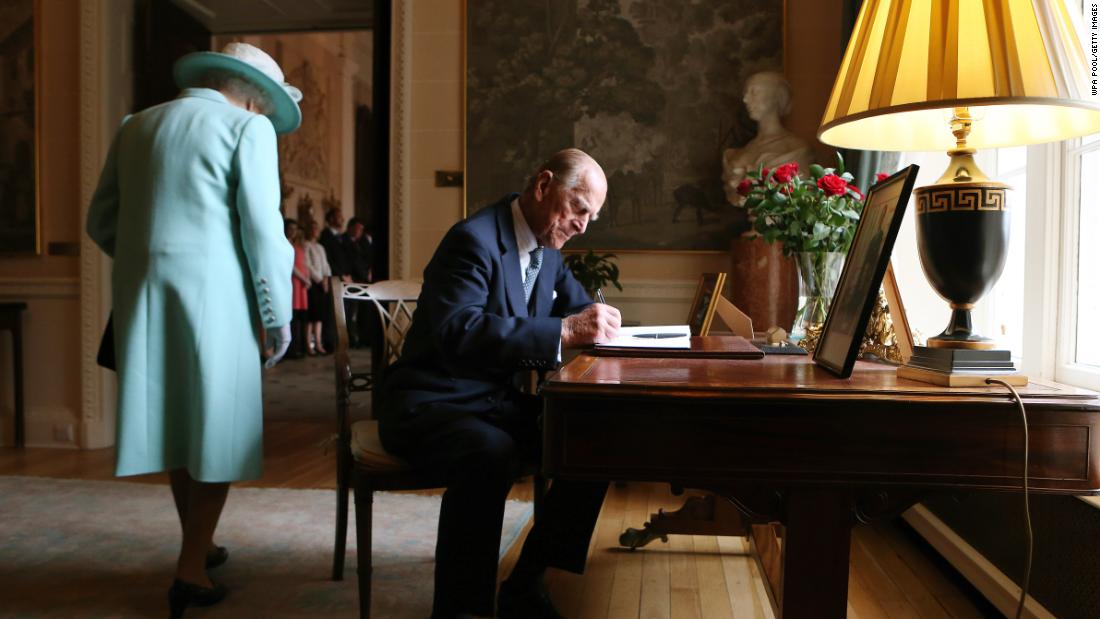 Prince Philip signs the guest book at Hillsborough Castle in Belfast, Northern Ireland, in June 2014.