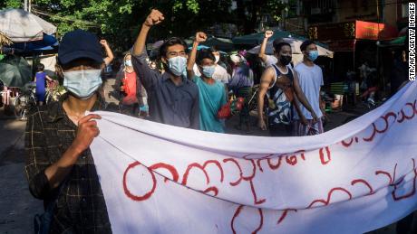 Protesters march during a demonstration against the military coup in Yangon on April 11, 2021. 