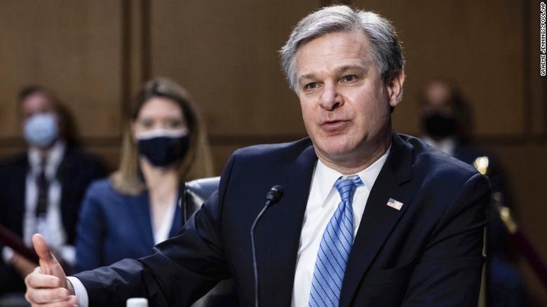 FBI director says bureau is not investigating QAnon conspiracy 'in its own right'