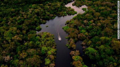 A boat speeds across the Jurura River in Carauari, Brazil, in 2020.