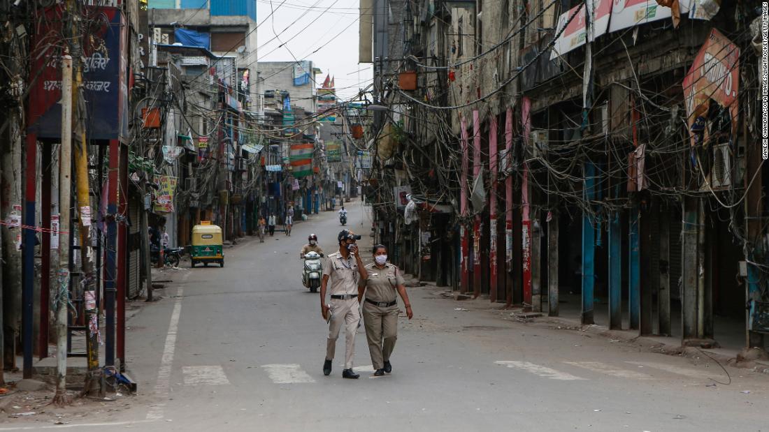 Police officers patrol a deserted street in New Delhi on April 20. The city is on lockdown until May 3.