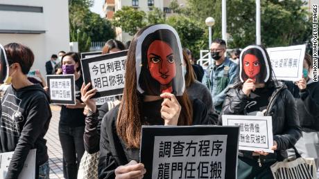 Hong Kong public broadcaster Radio Television Hong Kong (RTHK) staffers wear masks depicting the journalist Nabela Qoser during a silent protest against the management&#39;s treatment of her outside Broadcasting House on January 28, 2021 in Hong Kong.