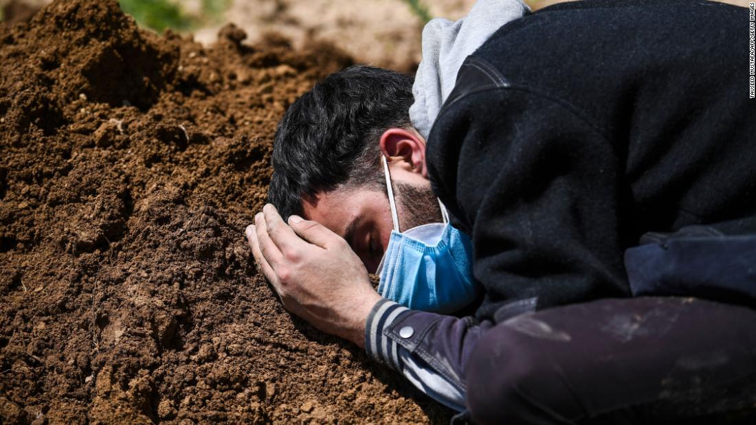 Umar Farooq mourns at the grave of his mother, a Covid-19 victim, in Srinagar on April 26.