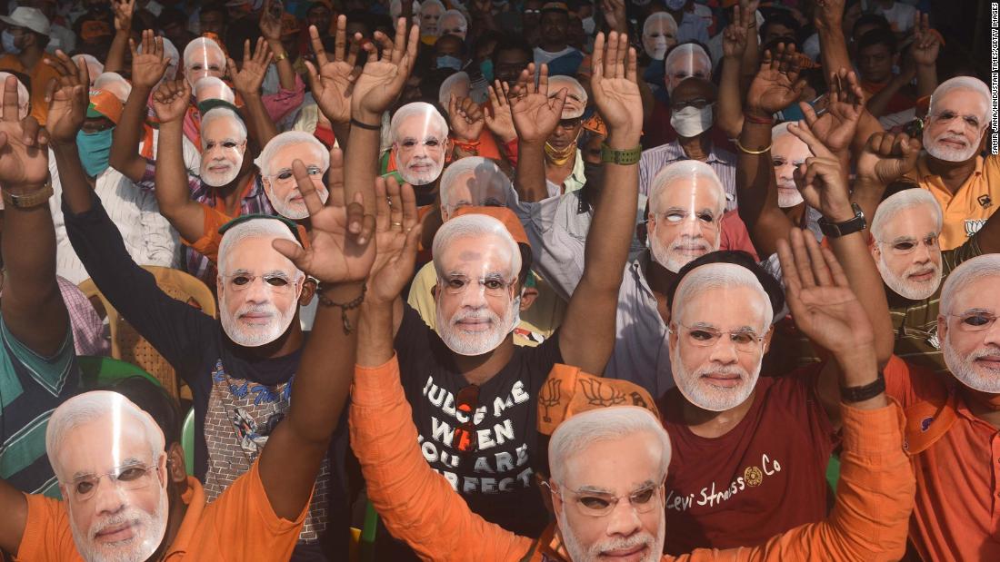 Supporters of the Bharatiya Janata Party wear masks of Prime Minister Narendra Modi during an election rally in Sonarpur on April 3.