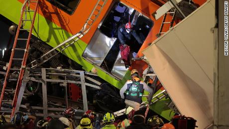 Emergency personnel search for accident survivors after a raised subway track collapsed on May 3 in Mexico City.