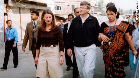 Bill and Melinda Gates walk on a street in December 2005 in Dhaka, Bangladesh, where the Bill and Melinda Gates Foundation funded health programs.