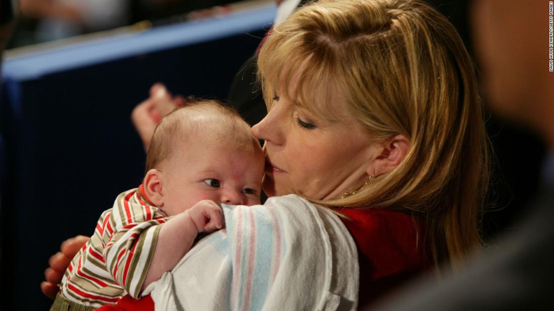 Cheney holds her 2-month-old son, Phillip, as President George W. Bush gave a speech at the Republican National Convention in 2004.