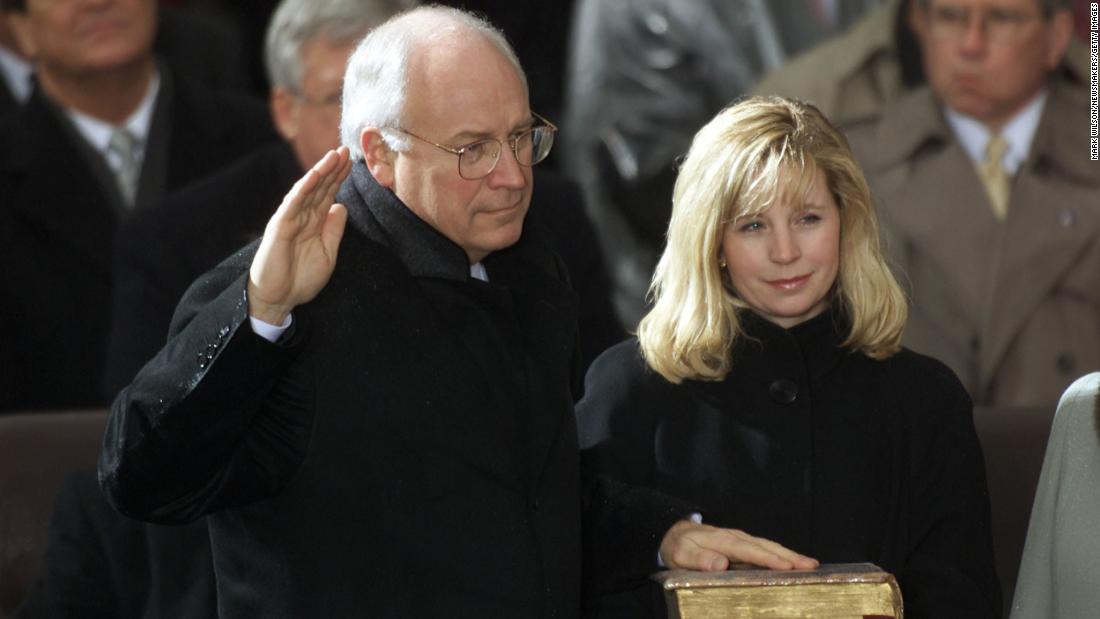Liz Cheney holds the Bible for her father as he&#39;s sworn in as vice president in 2001.