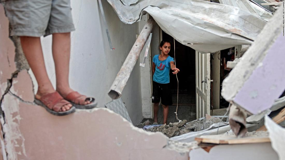 Palestinian children inspect a damaged bedroom following an Israeli airstrike at Gaza City&#39;s al-Shati Refugee Camp on May 11.