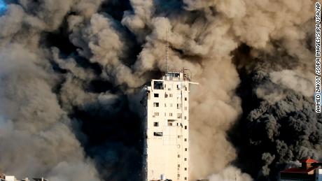 Smoke rises from a tower building destroyed by Israeli airstrikes.