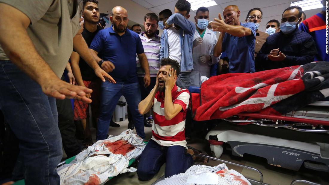 Relatives mourn over the bodies of the Abu Khatab family, who were killed in an Israeli airstrike, at the Shifa Hospital morgue in Gaza City on May 15.