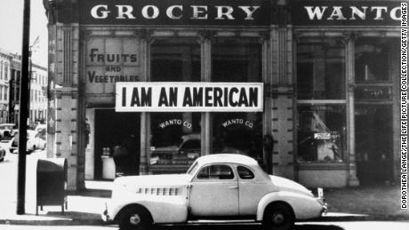 A sign reading: &#39;I AM AN AMERICAN&#39;, on the Wanto Co grocery store in Oakland, California, the day after the attack on Pearl Harbor, 8th December 1941. 