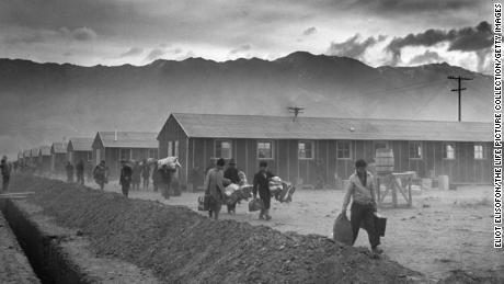The first group of 82 Japanese-Americans arrive at the Manzanar internment camp (or &#39;War Relocation Center&#39;) carrying their belongings in suitcases and bags in 1942. 