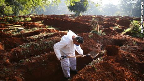 A cemetery worker digs graves for the bodies of people who died of Covid-19 in Sao Paulo this month.