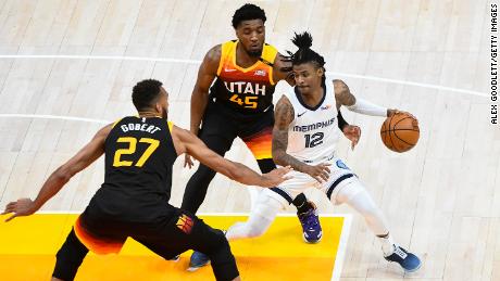 Ja Morant of the Memphis Grizzlies attempts to drive between Donovan Mitchell and Rudy Gobert of the Utah Jazz in Game 2 of the Western Conference First Round Playoff Series on May 26, 2021.