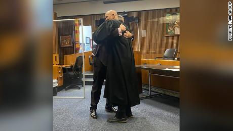Edward Martell and Judge Bruce Morrow&#39;s hugging after Martell was sworn in.