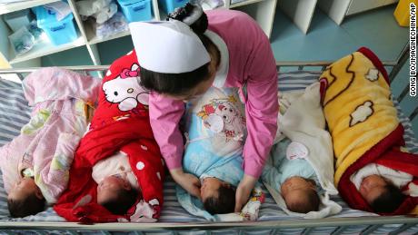 China eases birth limits to allow families to have three children