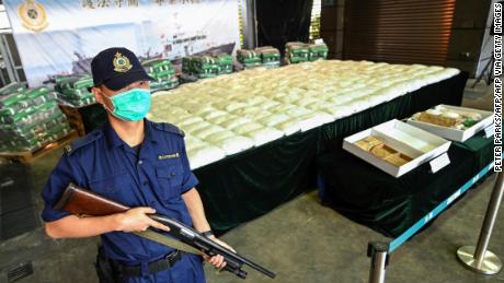 An armed customs officer guards a record seizure of over 500 kilograms of methamphetamine during a news conference in Hong Kong in November.