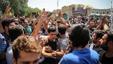 In this June 2018 photo, a group of protesters chant slogans at the main gate of the Old Grand Bazaar, in Tehran, Iran. The case of 27-year-old Navid Afkari has drawn the attention of a social media campaign that portrays him and his brothers as victims targeted over participating in protests against Iran&#39;s Shiite theocracy in 2018. 