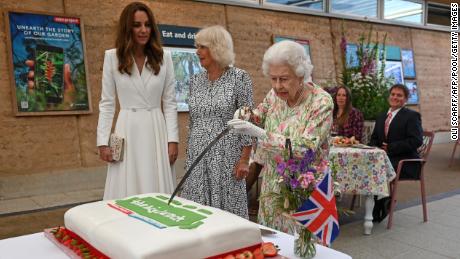 Britain&#39;s Queen Elizabeth II cuts a cake to celebrate The Big Lunch initiative at The Eden Project in Cornwall on Friday. 