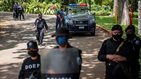 Riot police stand guard outside the house of pre-presidential candidate Cristiana Chamorro in Managua on June 2.