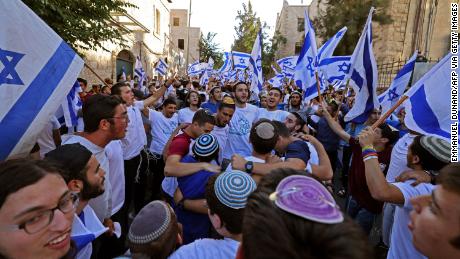 Israelis lift flags as they gather near Jerusalem&#39;s Old City ahead of the flag march on Tuesday.