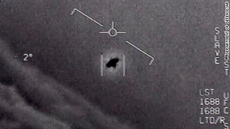 The image from video provided by the Department of Defense shows an unexplained object as it soars high along the clouds, traveling against the wind. 