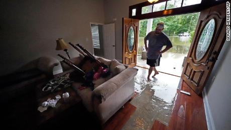 Danny Gonzales walks in his flooded house Saturday after Claudette passed through Slidell, Lousiana.