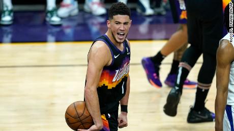 Booker celebrates in the closing seconds of the second half of Game One against the Clippers.