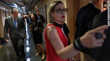 Sens. Kyrsten Sinema and Joe Manchin arrive for a bipartisan meeting on infrastructure in June.