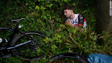 Switzerland&#39;s Marc Hirschi lies on the side of the road after crashing in the Tour de France.