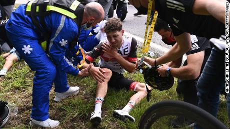 Team UAE Emirates&#39; Marc Hirschi receives medical treatment after crashing during the first stage of the Tour de France.