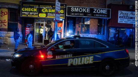 A Baltimore police officer patrols Friday, April 17, 2020, in the area of unrest after Freddie Gray, who lived nearby, was arrested more than five years ago.  