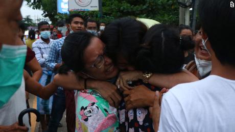 A man is hugged by two women after being released from Insein Prison in Yangon, Myanmar, 在六月 30.