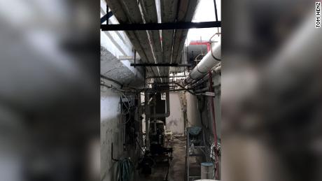 A newly obtained 2018 photograph shows the earlier stages of a crack in the concrete of the pool equipment room in the Surfside, Florida, building that collapsed. The 2018 photograph, shared with CNN by Tom Henz, a mechanical engineer whose firm did an electrical and mechanical inspection of the Champlain Towers South building that year as part of its 40-year recertification process, shows a crack around the edge of a beam running along the top of the room.  