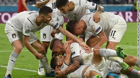 Nicolo Barella is mobbed by his teammates after scoring Italy&#39;s opening goal.