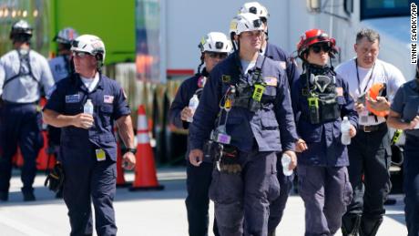 Members of the South Florida Urban Search and Rescue team walk near Champlain Towers South.