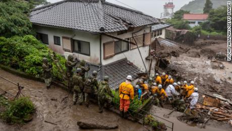 ATAMI, JAPAN - JULY 04: Rescue workers search for missing people at the site of a landslide on July 04, 2021 in Atami, Shizuoka, Japan. A rescue operation is underway after a landslide, caused by torrential rain, tore through the Japanese resort city of Atami on Saturday, killing two and leaving around twenty missing. (Photo by Yuichi Yamazaki/Getty Images)