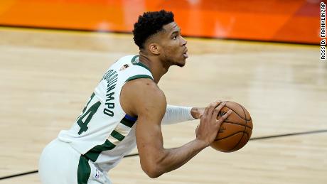 Milwaukee Bucks forward Giannis Antetokounmpo shoots a foul shot during the first half of Game 1 of basketball&#39;s NBA Finals against the Phoenix Suns, Tuesday, July 6, 2021, in Phoenix.