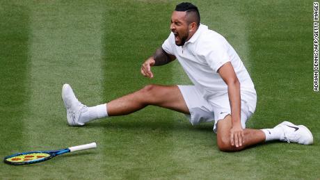 Australia&#39;s Nick Kyrgios falls as he returns to France&#39;s Ugo Humbert during their men&#39;s singles first round match on the third day of the 2021 Wimbledon Championships.