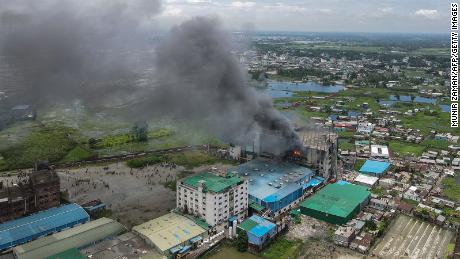 TOPSHOT - In this aerial photo taken on July 9, 2021 smoke bellows from a massive fire that broke out in a beverage and food factory in Rupganj in the district Narayanganj. (Photo by Munir Uz zaman / AFP) (Photo by MUNIR UZ ZAMAN/AFP via Getty Images)