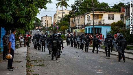Riot police walk the streets after a demonstration against the government of Cuban President Miguel Diaz-Canel in Arroyo Naranjo Municipality, Havana on July 12.